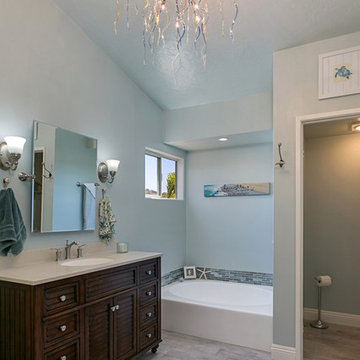 Oceanside Master Bathroom with Dark Vanity and Chandelier
