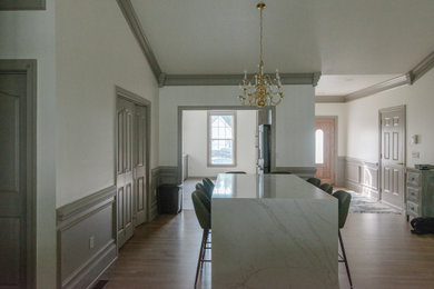 Kitchen/dining room combo - large contemporary light wood floor, brown floor and wainscoting kitchen/dining room combo idea in Other with beige walls
