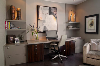 Study room - large contemporary built-in desk dark wood floor study room idea in Miami with gray walls
