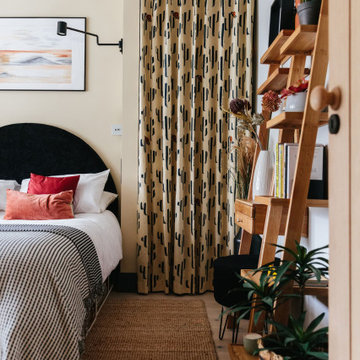 Modern Warm Neutral Bedroom with Pops of Burnt Red