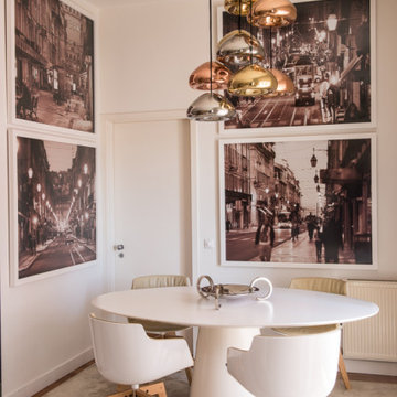 Chiado dining area with round table and photography wall