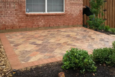 Example of a small front yard concrete paver patio design in Dallas
