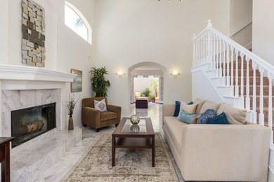 Small transitional formal and enclosed porcelain tile living room photo in Los Angeles with white walls, a standard fireplace, a tile fireplace and no tv