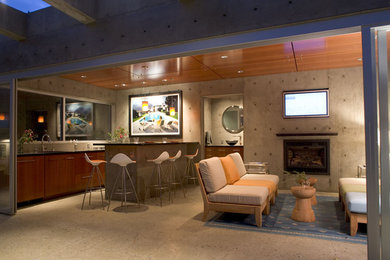 Example of a minimalist backyard concrete patio kitchen design in San Francisco with a roof extension