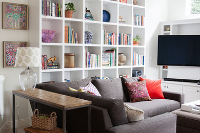 Example of a mid-sized eclectic open concept carpeted living room design in Other with white walls, a standard fireplace, a stone fireplace and a wall-mounted tv