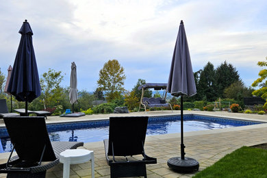 Design ideas for a backyard concrete paver landscaping in Seattle.