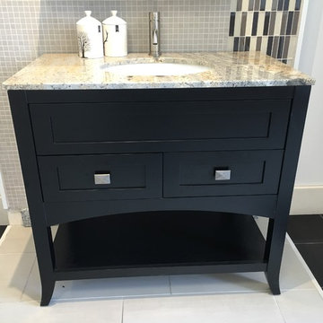 Contemporary vanity cabinets with granite counter top and under mount oval white