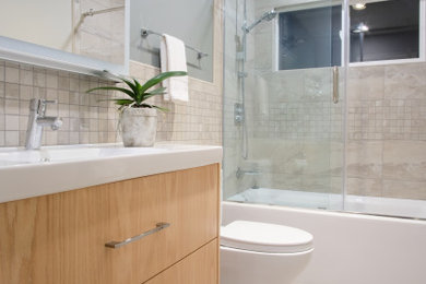 Inspiration for a contemporary kids' beige tile and mosaic tile ceramic tile and beige floor bathroom remodel in San Francisco with flat-panel cabinets, light wood cabinets, a one-piece toilet, gray walls, an integrated sink, white countertops, a niche and a floating vanity