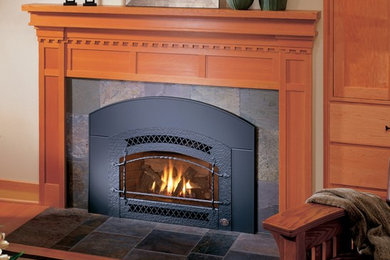 Mid-sized elegant formal and enclosed medium tone wood floor living room photo in Other with a standard fireplace, a stone fireplace, beige walls and a concealed tv