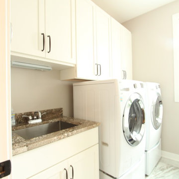 White painted cabinets used in compact laundry room