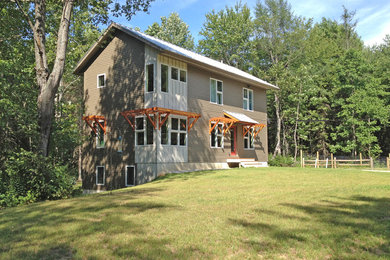 Example of a mid-sized trendy two-story concrete fiberboard exterior home design in Portland Maine