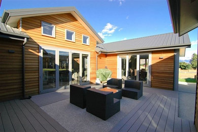 Photo of a large contemporary courtyard patio in Dunedin with decking and no cover.
