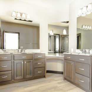 Bathroom - mid-sized transitional master laminate floor bathroom idea in Milwaukee with recessed-panel cabinets, dark wood cabinets, white walls, an undermount sink and granite countertops