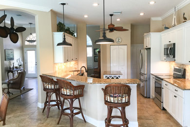 Mid-sized trendy kitchen photo in Tampa with shaker cabinets, white cabinets, granite countertops, beige backsplash, stainless steel appliances, an island and multicolored countertops