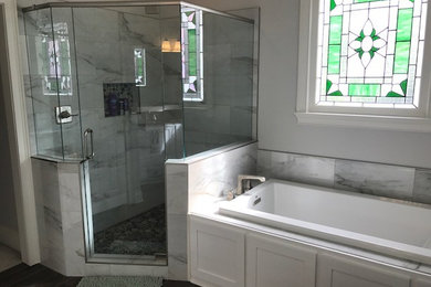 Bathroom - mid-sized traditional master white tile dark wood floor and brown floor bathroom idea in Atlanta with shaker cabinets, white cabinets, a one-piece toilet, gray walls and a hinged shower door