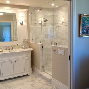 Example of a mid-sized classic master white tile and marble tile marble floor and white floor alcove shower design in San Francisco with recessed-panel cabinets, white cabinets, beige walls, an undermount sink, marble countertops and a hinged shower door