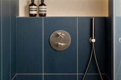 Inspiration for a bathroom in London with blue tiles, porcelain tiles and a hinged door.