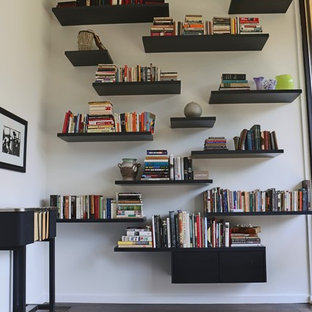 Small modern study in Atlanta with white walls and dark hardwood flooring.