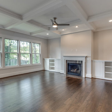Living Room w/Coffered Ceiling, Upgraded Granite Fireplace, and Custom Built-in'