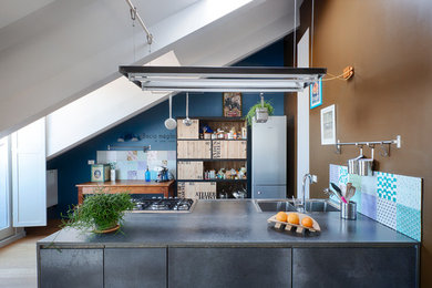 Inspiration for an industrial galley kitchen in Turin with a double-bowl sink, a peninsula, flat-panel cabinets and grey cabinets.