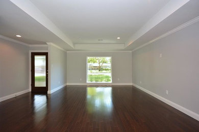 Inspiration for a mid-sized timeless formal and open concept dark wood floor and brown floor living room remodel in Houston with brown walls