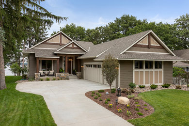 Inspiration for a large transitional brown house exterior in Minneapolis with a shingle roof.