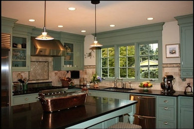 Example of a mid-sized classic l-shaped kitchen design in Seattle with an undermount sink, shaker cabinets, blue cabinets, solid surface countertops, beige backsplash, ceramic backsplash, stainless steel appliances and an island