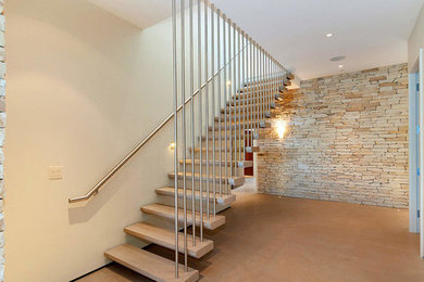 Staircase - modern concrete floating metal railing staircase idea in Vancouver with concrete risers