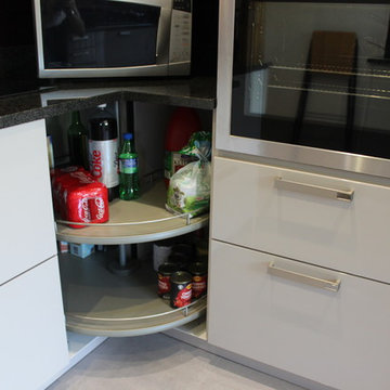 A German Kitchen with Glass Splashback in Stanmore by Kudos Interior Designs