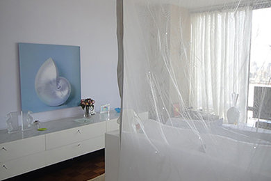 Example of a large minimalist master medium tone wood floor and brown floor bedroom design in New York with multicolored walls