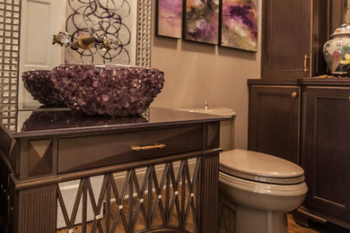 Inspiration for a small timeless gray tile dark wood floor powder room remodel in Other with furniture-like cabinets, gray cabinets, a vessel sink, a two-piece toilet and beige walls