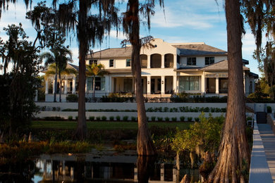 Huge island style two-story stucco exterior home photo in Orlando