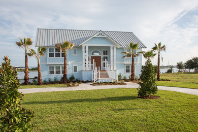 Inspiration for a large tropical blue two-story concrete fiberboard exterior home remodel in Jacksonville