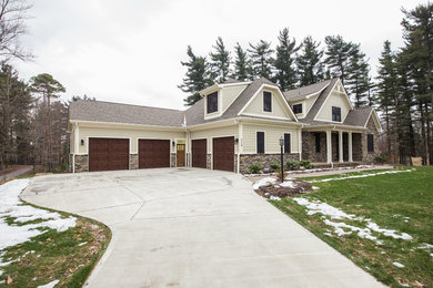 Large arts and crafts beige two-story mixed siding exterior home photo in Other with a tile roof