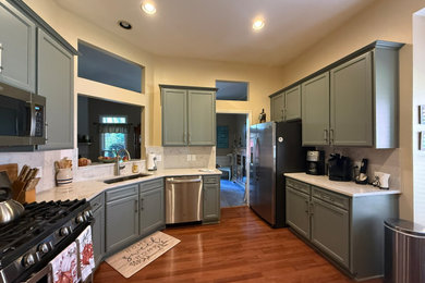 Mid-sized transitional enclosed kitchen photo in Atlanta with shaker cabinets, green cabinets, quartz countertops and quartz backsplash