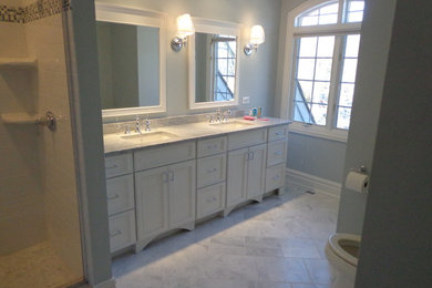 Corner shower - mid-sized traditional master marble floor and gray floor corner shower idea in Chicago with beaded inset cabinets, white cabinets, gray walls, an undermount sink, marble countertops, gray countertops and a hinged shower door