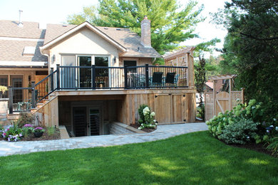 Deck - large traditional backyard deck idea in Toronto