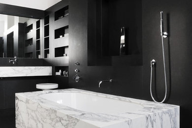 Photo of a mid-sized modern master bathroom in Paris with an undermount tub, a shower/bathtub combo, black walls and a wall-mount sink.