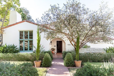 Example of a large tuscan white two-story stucco exterior home design in Sacramento with a hip roof