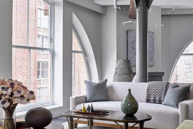 Example of an urban open concept living room design in New York