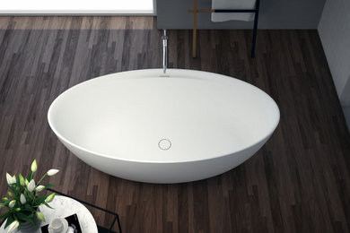 Ispirazione per una stanza da bagno padronale minimalista di medie dimensioni con ante bianche e vasca freestanding