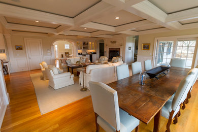 This is an example of a traditional living room in Boston with light hardwood floors.