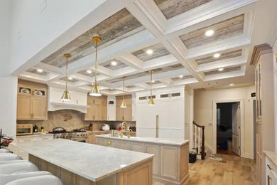 Example of a large french country coffered ceiling eat-in kitchen design in New York with two islands