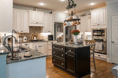 Mid-sized transitional u-shaped eat-in kitchen photo in Raleigh with raised-panel cabinets, white cabinets and an island