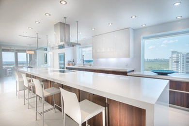 Minimalist eat-in kitchen photo in Miami with quartz countertops, white backsplash, white appliances, an integrated sink, flat-panel cabinets, medium tone wood cabinets and an island