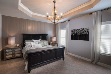 Photo of a large arts and crafts master bedroom in Atlanta with grey walls.