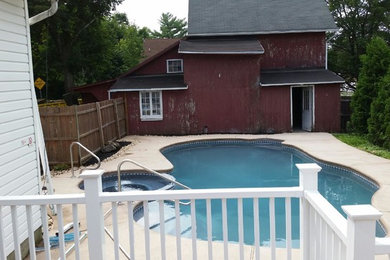 This is an example of a mid-sized traditional backyard round pool in Philadelphia.