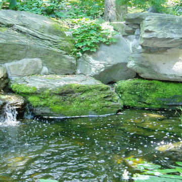 Grotto with pool house and running stream