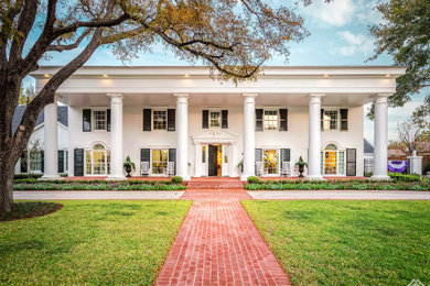 Inspiration for a huge timeless white two-story exterior home remodel in Dallas