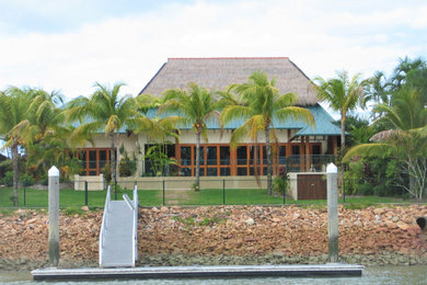 Photo of a large asian home design in Cairns.
